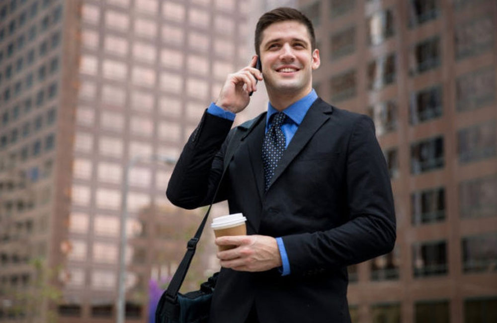 young lawyer holding a coffee and having a call
